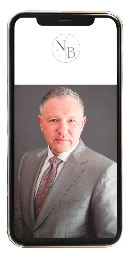 A smartphone screen showing a professional headshot of a middle-aged male doctor in a grey suit and patterned tie, displayed under the "NB" logo. The image appears on a mobile app interface, likely part of a “Meet Your Doctor” or appointment selection feature.