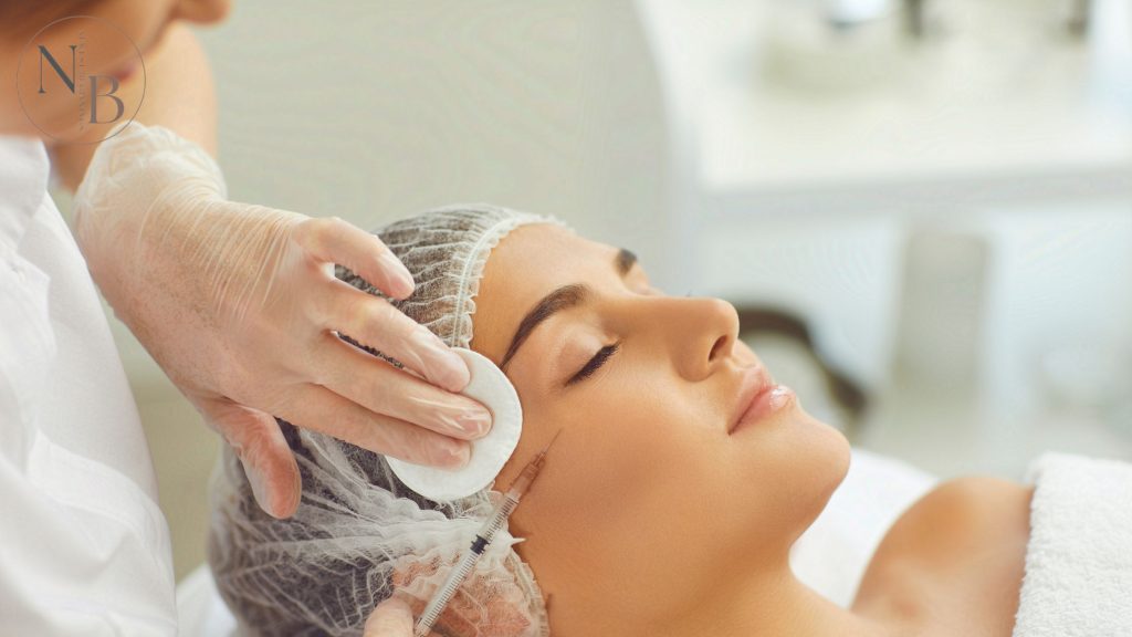 A woman receiving a Botox injection near the outer eye area to reduce crow’s feet and fine lines.